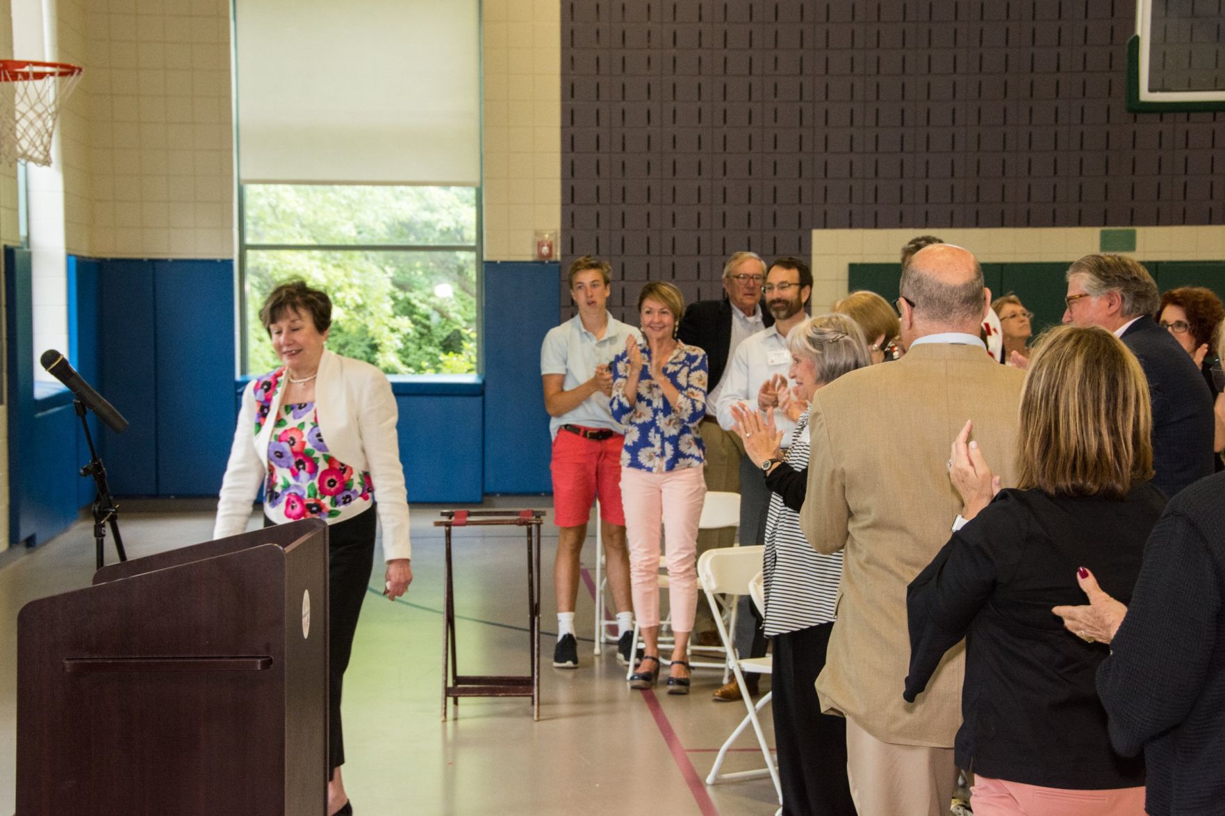 Judy Zafft approaches the podium as the crowd gives her a standing ovation, at the Friends of Miriam Luncheon